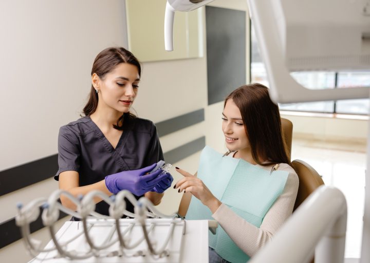dentist-holding-transparent-aligners-for-teeth-correction-for-a-patient-in-dentistry-clinic.jpg
